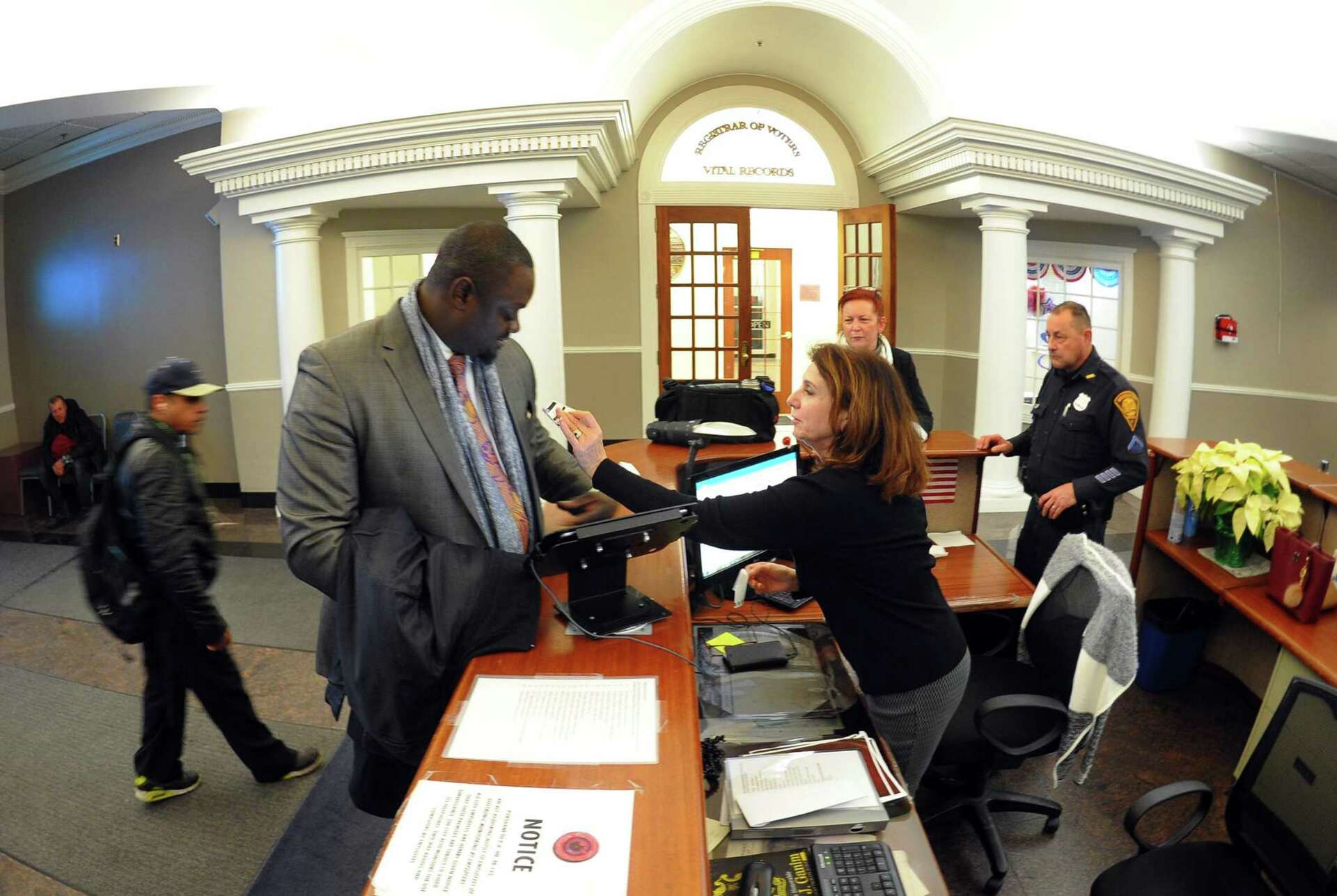 Visitors and staff using the visitor registration system at Bridgeport Government Center